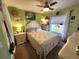 Bedroom with floral bedding, dresser, and ceiling fan at 2250 Villa Green Ave, North Port, FL 34288