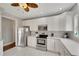 Modern kitchen with white cabinets, stainless steel appliances and tile backsplash at 2794 Parlay Ln, North Port, FL 34286