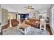 Open living area with brown leather couches and a view into the kitchen and dining area at 2794 Parlay Ln, North Port, FL 34286