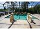 Inviting pool area with covered patio, water features, and tranquil water views at 3507 Terin Ct, Punta Gorda, FL 33950