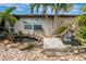 Landscaped front yard features a pond, waterfall, and stone accents at 3545 Syracuse St, Port Charlotte, FL 33952