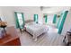 Bright bedroom with a king-size bed and teal curtains at 416 Torrington St, Port Charlotte, FL 33954