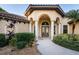 House exterior featuring a tiled roof, arched entryway, and landscaped grounds at 4201 Eagle Nest Ct, Port Charlotte, FL 33948