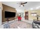 Gathering room with a red accent chair, black leather couch, and views to the dining and kitchen areas at 650 Chamber Nw St, Port Charlotte, FL 33948