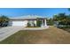 Single-story home with attached garage and manicured lawn at 650 Chamber Nw St, Port Charlotte, FL 33948