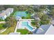 Aerial view of community pool, tennis courts, and building at 1162 Green Oak Trl, Port Charlotte, FL 33948