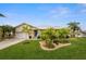Single-story home with a landscaped yard and attached garage at 1230 Swan Ct, Punta Gorda, FL 33950
