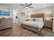 Main bedroom with wood-framed bed, dresser, and ensuite bathroom at 1230 Swan Ct, Punta Gorda, FL 33950
