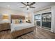 Bright bedroom with wood floors, king bed, and sliding glass doors leading to a patio at 1230 Swan Ct, Punta Gorda, FL 33950