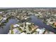 Aerial view of a waterfront community with many houses and canals at 1230 Swan Ct, Punta Gorda, FL 33950