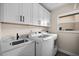 Laundry room with white cabinets, granite countertop, and a new washer and dryer at 1230 Swan Ct, Punta Gorda, FL 33950