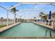 Inviting, screened-in pool with patio furniture and water views at 1230 Swan Ct, Punta Gorda, FL 33950