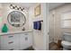 Bathroom with white vanity, round mirror, and a separate shower at 1230 Swan Ct, Punta Gorda, FL 33950