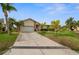 Single story home with attached two-car garage and lush landscaping at 1230 Swan Ct, Punta Gorda, FL 33950
