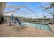 Inviting screened pool with patio furniture and canal views at 1230 Swan Ct, Punta Gorda, FL 33950