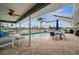 Relaxing pool area with patio furniture and canal views at 1230 Swan Ct, Punta Gorda, FL 33950