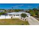 Elevated view of a single-story home with pool, shed, and white fence at 170 Chelsea Nw Ct, Port Charlotte, FL 33952