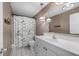 Bathroom with white vanity, shower/tub combo, and decorative light fixtures at 170 Chelsea Nw Ct, Port Charlotte, FL 33952