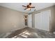 Bedroom with ceiling fan, closet, and ensuite bathroom access at 170 Chelsea Nw Ct, Port Charlotte, FL 33952