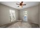 Empty bedroom with ceiling fan, window, and door to the outside at 170 Chelsea Nw Ct, Port Charlotte, FL 33952