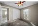 Empty bedroom with ceiling fan, closet, and door to another room at 170 Chelsea Nw Ct, Port Charlotte, FL 33952