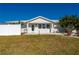 Welcoming front entrance of a single-story home with a white facade and green lawn at 170 Chelsea Nw Ct, Port Charlotte, FL 33952