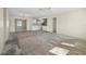 Spacious living room and kitchen area with white cabinetry, awaiting new flooring at 170 Chelsea Nw Ct, Port Charlotte, FL 33952