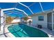 Pool area with a screen enclosure and a view of the back of the house at 170 Chelsea Nw Ct, Port Charlotte, FL 33952
