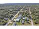 Aerial view of a residential area showing homes, roads, and lush greenery at 17152 Wintergarden Ave, Port Charlotte, FL 33948