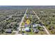 Aerial view showcasing the property nestled among lush greenery with a long driveway at 17152 Wintergarden Ave, Port Charlotte, FL 33948