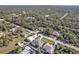 Aerial view of a residential area showing homes, roads, and lush greenery at 17152 Wintergarden Ave, Port Charlotte, FL 33948