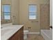 Well-lit bathroom with a vanity and a bathtub with tile surround at 17152 Wintergarden Ave, Port Charlotte, FL 33948