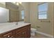 Bathroom featuring a wooden vanity, neutral walls, a toilet, and tiled shower at 17152 Wintergarden Ave, Port Charlotte, FL 33948