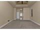 Comfortable bedroom with carpet, neutral tones, and a ceiling fan, with access to the bathroom at 17152 Wintergarden Ave, Port Charlotte, FL 33948