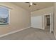 Neutral bedroom with a ceiling fan, a window and a double door closet at 17152 Wintergarden Ave, Port Charlotte, FL 33948
