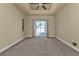 Relaxing bedroom with carpet, neutral tones, a ceiling fan and sliding glass doors to the backyard at 17152 Wintergarden Ave, Port Charlotte, FL 33948