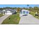 Home exterior with detached garage and palm trees at 17152 Wintergarden Ave, Port Charlotte, FL 33948