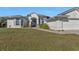 Home exterior has a manicured lawn and an attached garage at 17152 Wintergarden Ave, Port Charlotte, FL 33948