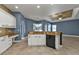 Bright, open kitchen with an island sink, granite countertops, and recessed lighting at 17152 Wintergarden Ave, Port Charlotte, FL 33948