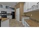 Spacious kitchen with granite countertops, white cabinets and black appliances at 17152 Wintergarden Ave, Port Charlotte, FL 33948