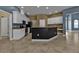 Large open kitchen featuring white cabinets, black appliances, and a central island at 17152 Wintergarden Ave, Port Charlotte, FL 33948