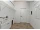 White laundry room with a sink, door, and wire shelving at 17152 Wintergarden Ave, Port Charlotte, FL 33948
