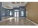 Spacious living room with high ceilings, tile flooring, and arched windows for plenty of natural light at 17152 Wintergarden Ave, Port Charlotte, FL 33948