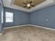Cozy living room with tile floors, neutral paint, and a ceiling fan to keep the space comfortable at 17152 Wintergarden Ave, Port Charlotte, FL 33948