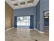 Bright and open living area with tiled floors, tall ceilings, and large windows at 17152 Wintergarden Ave, Port Charlotte, FL 33948