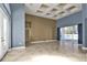 Open-plan living room with tile floors, high ceilings, and natural light from glass doors at 17152 Wintergarden Ave, Port Charlotte, FL 33948