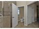 View of bathroom with tile flooring, tile shower, toilet, storage closet and open doorway at 17152 Wintergarden Ave, Port Charlotte, FL 33948