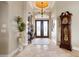 Elegant entryway with double doors, hardwood floors, and grand clock at 238 Lido Dr, Punta Gorda, FL 33950