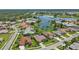 Aerial view of a community by a lake with various houses at 2388 Silver Palm Rd, North Port, FL 34288