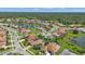 Aerial view of a community with houses, roads and a lake at 2388 Silver Palm Rd, North Port, FL 34288